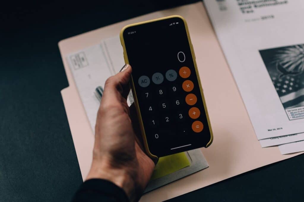 A hand holding a phone What Are Income Share Agreements?