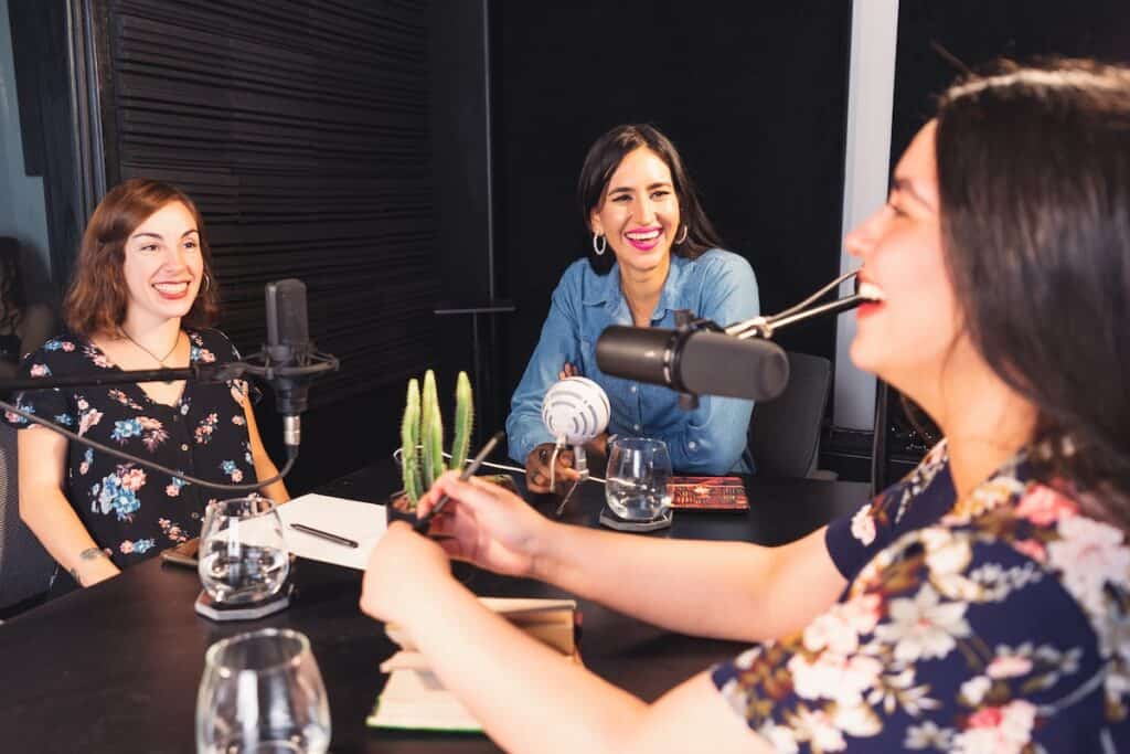 Three women recording a podcast.