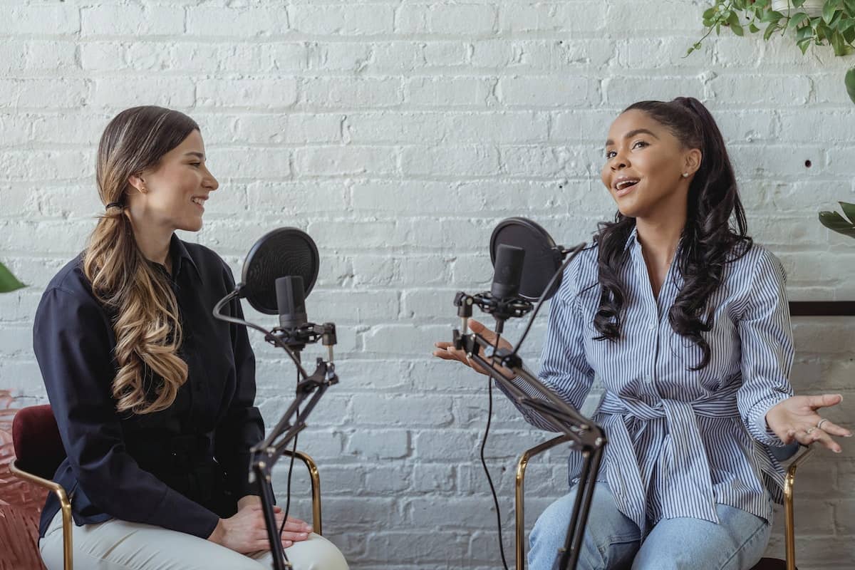 Two women recording a podcast.