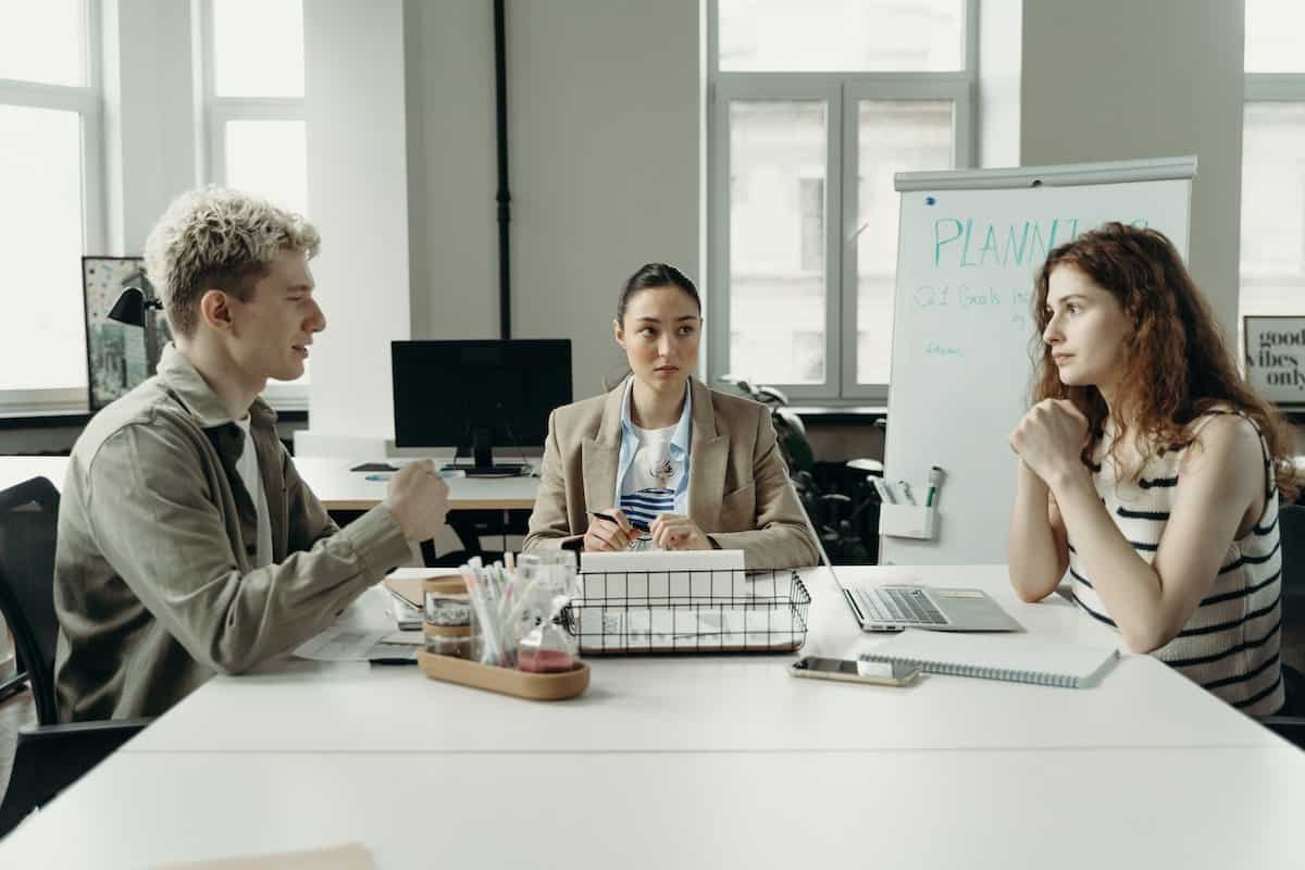 Three people in a meeting.