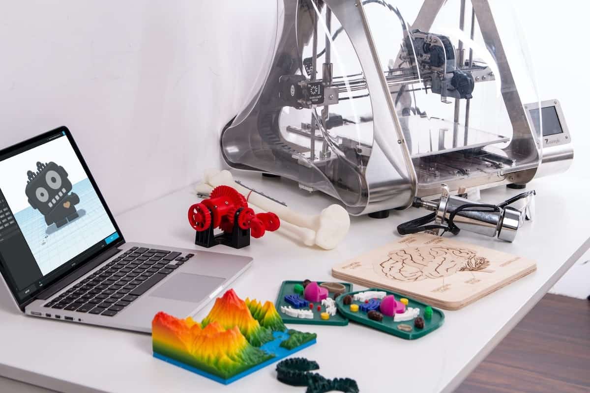 3D objects, laptop, and 3D printer on a table