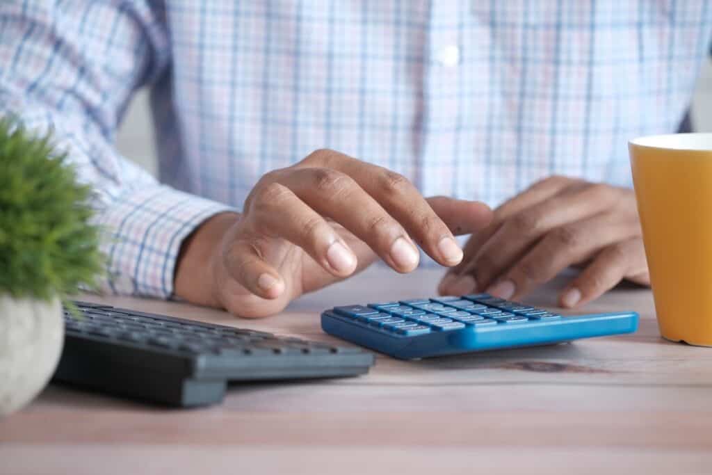 An accountant calculating business finances on calculator.